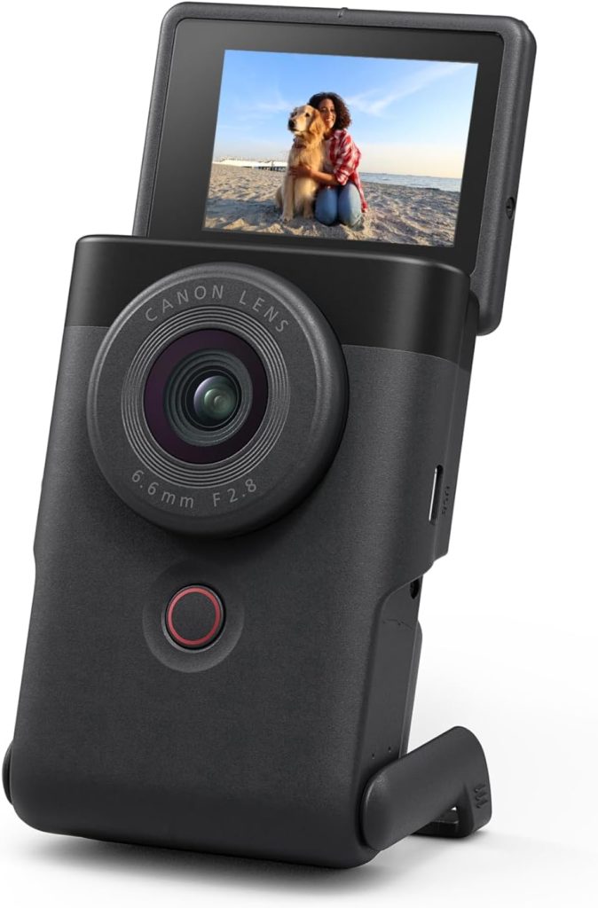 Canon PowerShot V10 Vlogging Camera with flip-up screen showing a woman and her dog on a beach, designed for content creators and vloggers.
