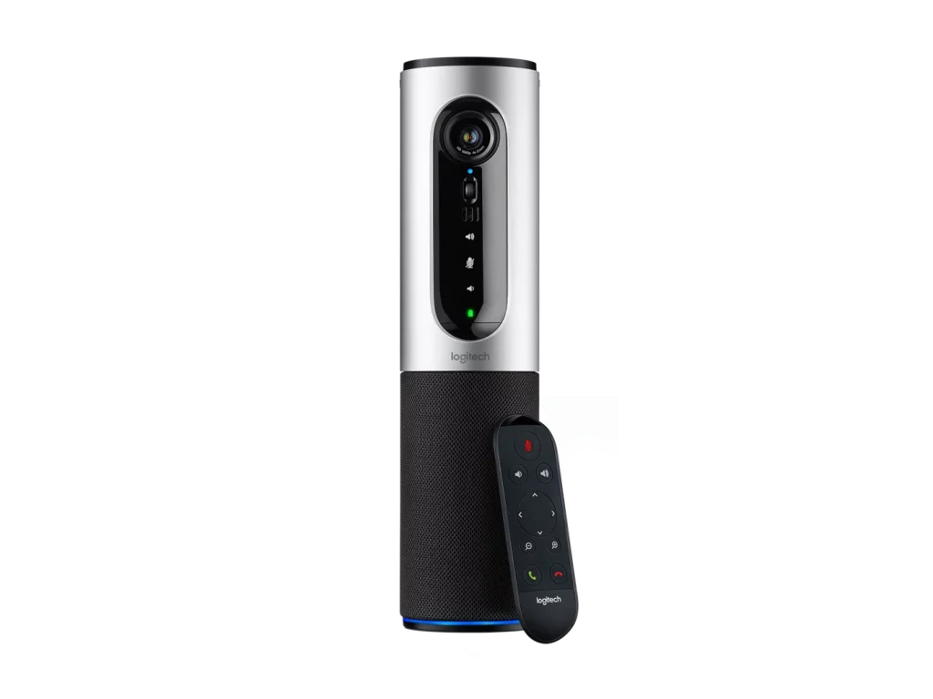 A sleek, cylindrical Logitech conference camera with a silver top and a black fabric-covered base, shown next to a black remote control.