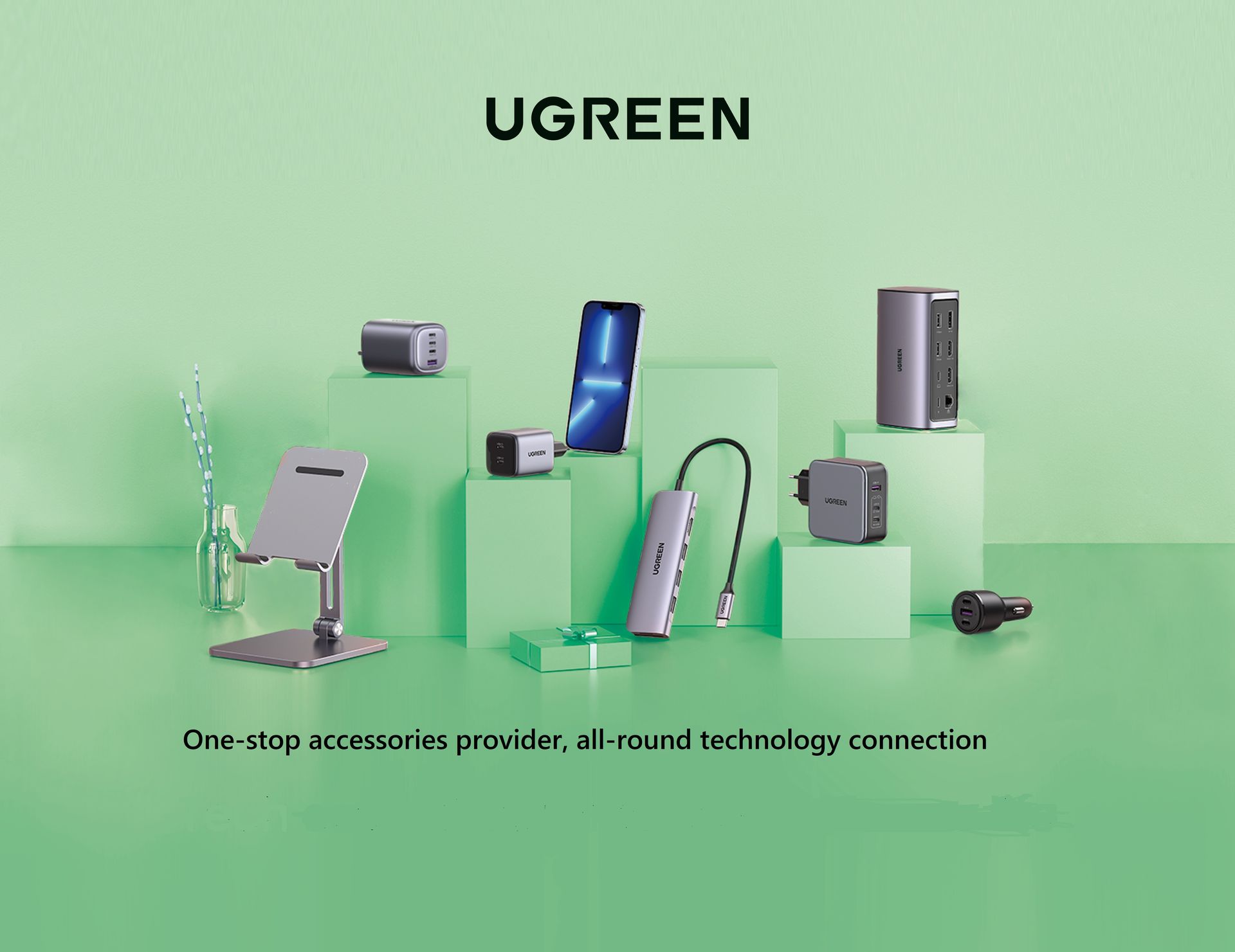 A collection of UGREEN electronic accessories, including multi-port wall chargers, a USB-C hub, a car charger, and a phone stand, displayed on green pedestals.