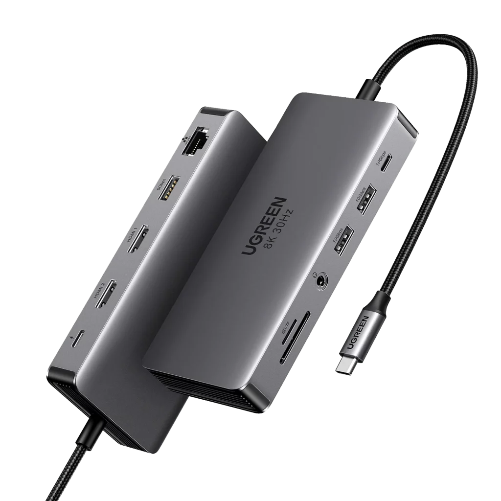 Two Ugreen Revodok Pro 11-in-1 USB-C hubs, both dark gray and rectangular, are shown at an angle, displaying multiple ports like HDMI, USB-A, Ethernet, and an SD card slot.