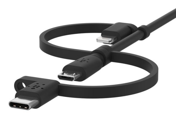 A dark gray or black universal charging cable is artfully arranged in a loose figure-eight shape against a bright white background. The cable features three distinct connectors: a USB-C connector on the far left, a Micro-USB connector positioned slightly above and to the right of the USB-C, and a Lightning connector at the top right. All connectors are attached to the main cable by short, integrated tether straps, allowing them to be interchangeable on a single cord.