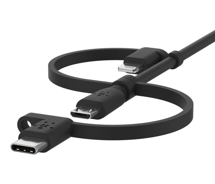 A dark gray or black universal charging cable is artfully arranged in a loose figure-eight shape against a bright white background. The cable features three distinct connectors: a USB-C connector on the far left, a Micro-USB connector positioned slightly above and to the right of the USB-C, and a Lightning connector at the top right. All connectors are attached to the main cable by short, integrated tether straps, allowing them to be interchangeable on a single cord.
