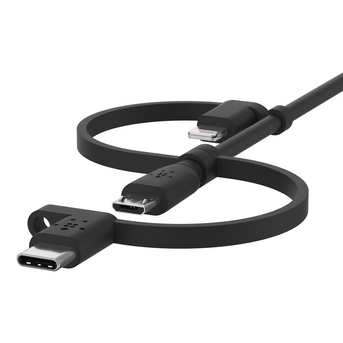A dark gray or black universal charging cable is artfully arranged in a loose figure-eight shape against a bright white background. The cable features three distinct connectors: a USB-C connector on the far left, a Micro-USB connector positioned slightly above and to the right of the USB-C, and a Lightning connector at the top right. All connectors are attached to the main cable by short, integrated tether straps, allowing them to be interchangeable on a single cord.