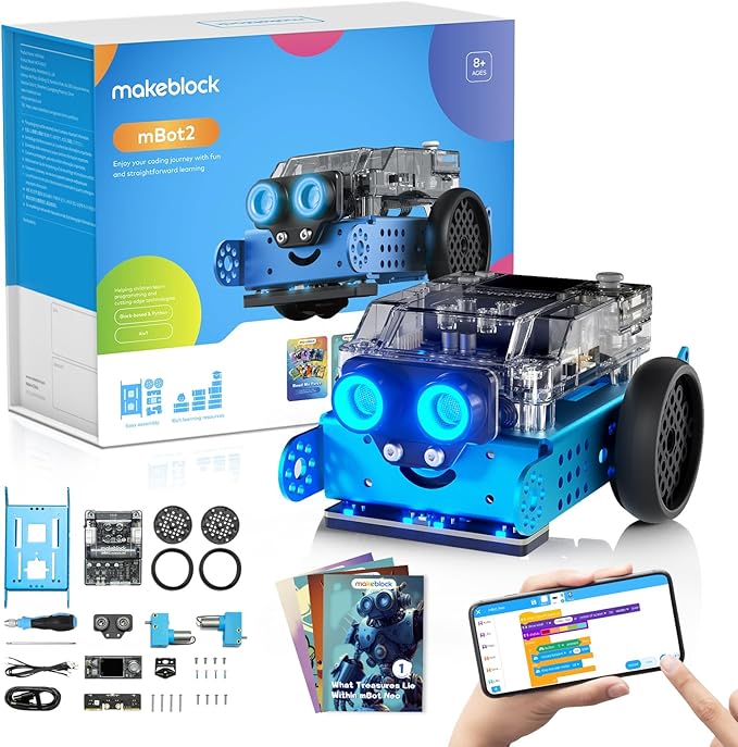 A blue makeblock mBot2 robot kit is displayed against a white background, accompanied by its packaging and various components. The assembled blue robot, with clear top casing and two large glowing blue "eyes," is prominent in the foreground. Behind it is the white and blue retail box, which features an image of the robot and details like "mBot2" and "Enjoy your coding journey with fun and straightforward learning." In the bottom left, an array of disassembled robot parts, including blue metal plates, wheels, and circuit boards, are laid out. Below the robot in the foreground, a smartphone screen shows a colorful coding interface, with a hand pointing to it. To the left of the phone, an instruction booklet with a robot illustration on its cover is also visible.