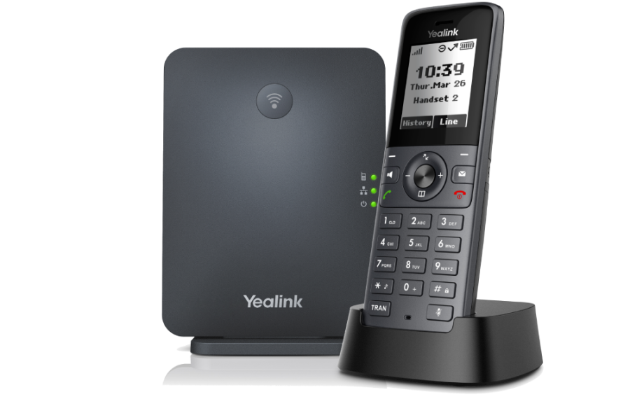 A Yealink W71P DECT IP phone system with a dark grey base station featuring a Wi-Fi symbol and status lights, and a black cordless handset in its charging cradle displaying the time, date, and call information, all set against a light grey background.