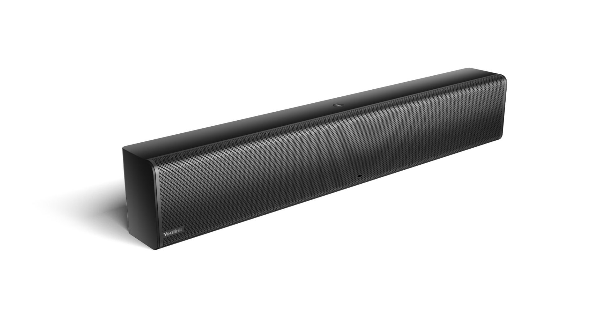 A black Yealink MSpeaker II, a rectangular soundbar, is angled slightly to the right against a white background, casting a soft shadow to its left. The speaker grille, featuring a fine, perforated pattern, covers the entire front surface. The Yealink logo is visible on the far left of the grille. A small, circular indicator light is subtly located near the center bottom edge. The device appears sleek and modern.