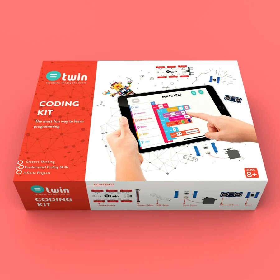 A red and white "Twin Science Coding Kit" box is displayed in a slightly elevated, angled shot against a white background. The front of the box features a large graphic of hands interacting with a tablet that shows a block-based coding interface, surrounded by small illustrations of various electronic components. The red side of the box prominently displays "@twin Spreading The Joy of Science" and "CODING KIT The most fun way to learn programming," along with a list of benefits: "Creative Thinking," "Fundamental Coding Skills," and "Infinite Projects." The white front of the box also includes an "AGES 8+" label and a "CONTENTS" section that lists components like "Coding Module," "Jumper Cables," "USB Cable," "Servo Motor," "Ultrasonic Sensor," and "Potentiometer," each with a small illustration.