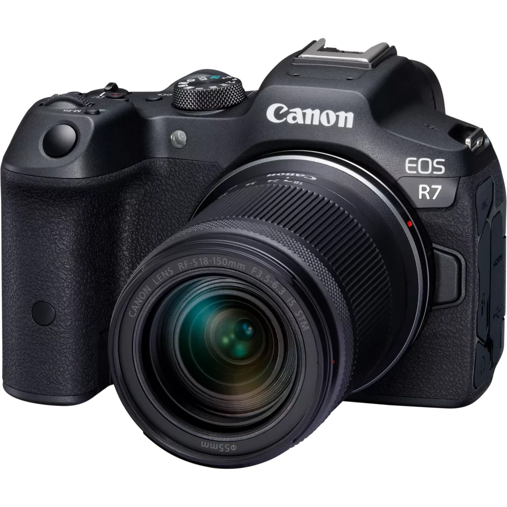 A professional product photo of a black Canon EOS R7 mirrorless camera with an RF-S 18-150mm lens attached, shot from a slight angle against a solid black background.