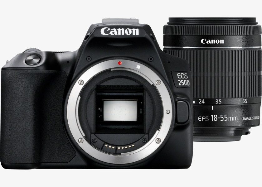 A product shot of a Canon EOS 250D camera and its kit lens on a white background. The camera body is on the left, with its lens mount exposed, and the lens is on the right, positioned slightly behind the camera.