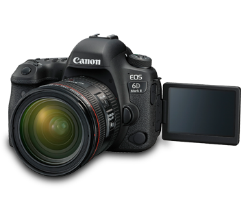 A black Canon EOS 6D Mark II DSLR camera with a Canon zoom lens attached, angled to the right. The camera's vari-angle LCD screen is fully extended and facing the viewer. The background is a solid black with faint white lines, possibly indicating a wireframe or grid.