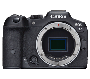 Canon EOS R7 mirrorless camera, front view, black body, lens mount cap removed revealing the sensor.