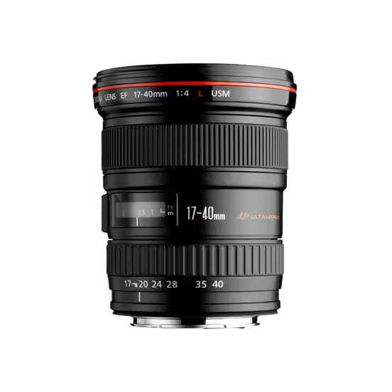 A product shot of a black Canon EF 17-40mm f/4L USM lens, standing upright on a black background. The red ring, a key feature of Canon's professional-grade L-series lenses, is clearly visible near the top of the lens. The focus distance window and zoom markings are also prominent.