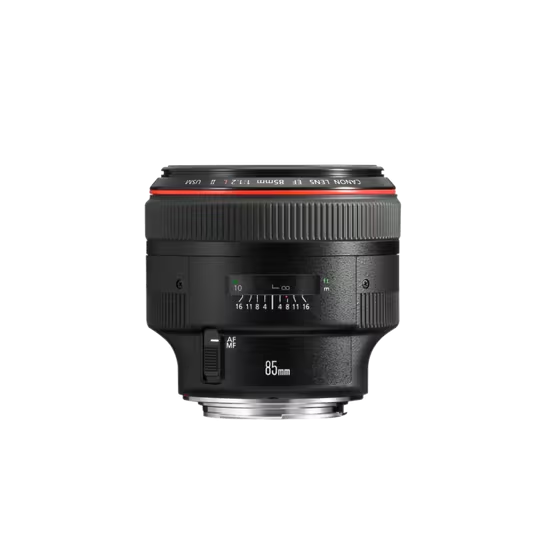 A professional studio product shot of a black Canon EF 85mm f/1.2L II USM lens, isolated on a black background. The lens is positioned to show the front element, the red ring, the focus distance window, and the AF/MF switch.